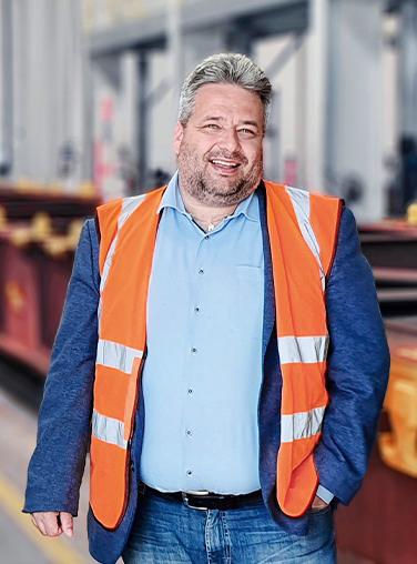 Matej Franc stands in front of an unloaded container train at Metrans Danubia (Photo)